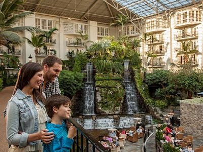 family by waterfalls and gardens inside Gaylord Opryland atrium