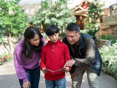 Family looking at scavenger hunt map at Gaylord Palms