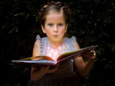 Young girl holding an open storybook