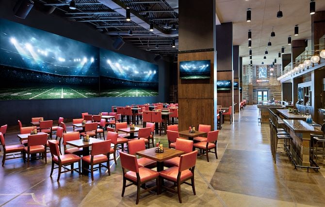 Sports bar dining area with large TV screen