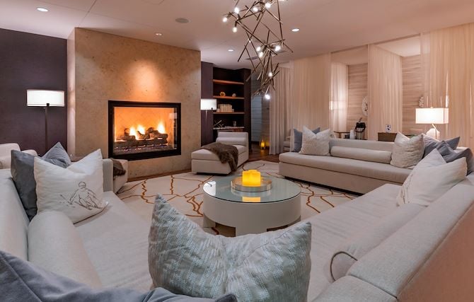 Spa relaxation room with couches and fireplace