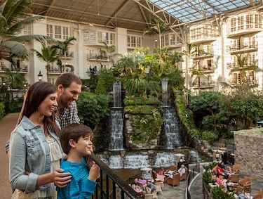 Family by waterfall in Cascades atrium at Gaylord Opryland