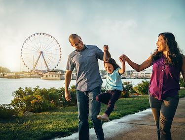 family in front of Capital Wheel