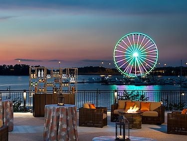 View of Potomac River and Capital Wheel from Pose Rooftop Bar at Gaylord National at sunset